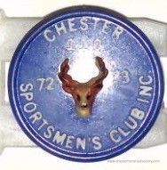 Chester Sportsmen Club pin #110: The image shows a circular emblem featuring a deer head at the center, set against a blue background. The text encircling the deer reads "Chester Sportsmen's Club Inc." and also includes the numbers "110 and "72-73." The emblem is part of a silver or gray metal structure, likely meant for display or attachment. The design suggests it represents a membership badge or token for a sportsmen or hunting club, indicating a specific year.