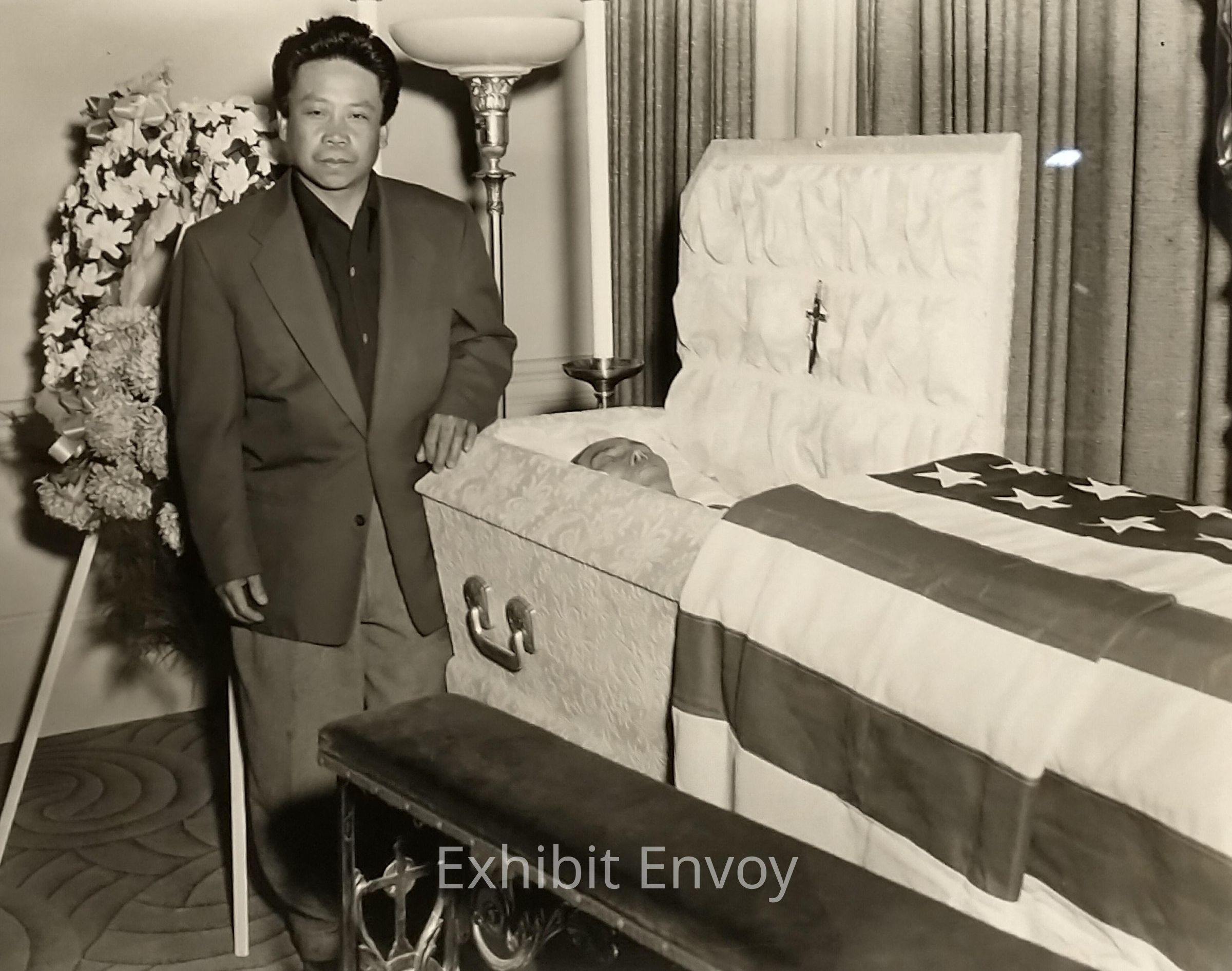 Photographer Ricardo Alvarado stands at his uncle's casket. Ciriaco Ocreto raised this young man in the United States. In exchange for room and board, Ciriaco and his nephews Ricardo and Marcelo worked as houseboys for the Schiller family in San Francisco by day. At night they worked as dishwashers in North Beach restaurants.