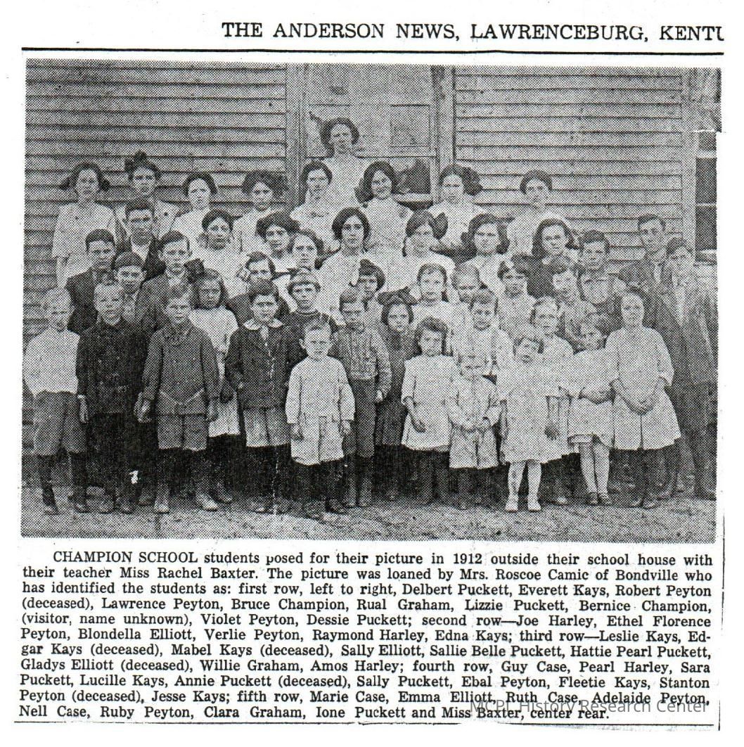 The teacher in a photograph was Miss Rachel Baxter. On the first row (l to r) are Delbert Puckett, Everett Kays, Robert Peyton, Lawrence Peyton, Bruce Champion, Rual Graham, Lizzie Puckett, Bernice Champion, an unknown visitor, Violet Peyton, and Dessie Peyton. The second row contains Joe Harley, Ethel Florence Peyton, Blondella Elliott, Verlie Peyton, Raymond Harley, and Edna kays. The third row features Leslie Kays, Edgar Kays, Mabel Kays, Sally Elliott, Sallie Belle Puckett, Hattie Pearl Puckett, Gladys Elliot, William Graham, and Amos Harley. The forth row contains Guy Case, Pearl Harley, Sar Puckett, Lucille Kays, Annie Puckett, Sally Puckett, Ebal Peyton, Fleetie Kays, Stanton Peyton, and Jesse Kays. The fifth row has Marie Case, Emma Elliott, Ruth Case, Adelaide Peyton, Nell Case, Ruby Peyton, Clara Graham, Ione Puckett, and Miss Baxter in the center rear.