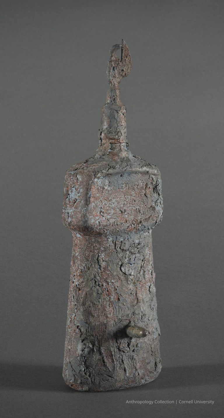 TRALLIB (Oil Container) | circa 1969-71 | Photo by Ann Cady, 2024 | ©2026 Norman Daly Art — Male Orientation: The image shows a cylindrical weathered object with a corroded, gray metallic surface, erect phallic protrusion, pointed head and a distinct finial top. Female orientation: The image shows a cylindrical weathered object with a corroded, gray metallic surface, female genitalia and breast area, pointed head and a distinct finial top.