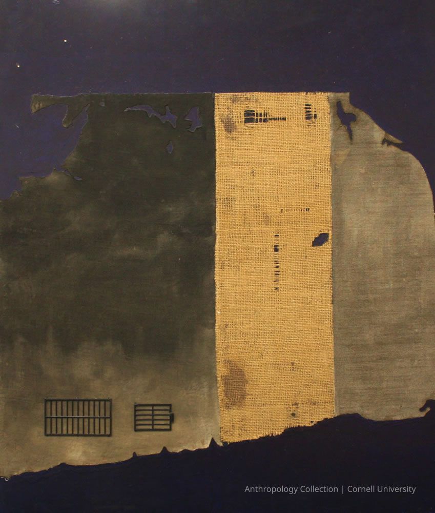 MAP OF TEMPLE OF PHALLOS AT TROLYDOS | 1966-71 | photo by Ann Cady, 2024 | ©2026 Norman Daly Art: This map features a striking composition with a deep blue background, overlaid with an abstract, weathered piece of fabric divided into three sections; the left section is dark and textured, the center portion is a burlap-like material with visible fraying and small perforations, while the right section is somewhat lighter and smoother, giving a sense of contrast and harmony; additionally, two grid-like patterns appear towards the bottom left, adding an interesting geometric element to the piece.