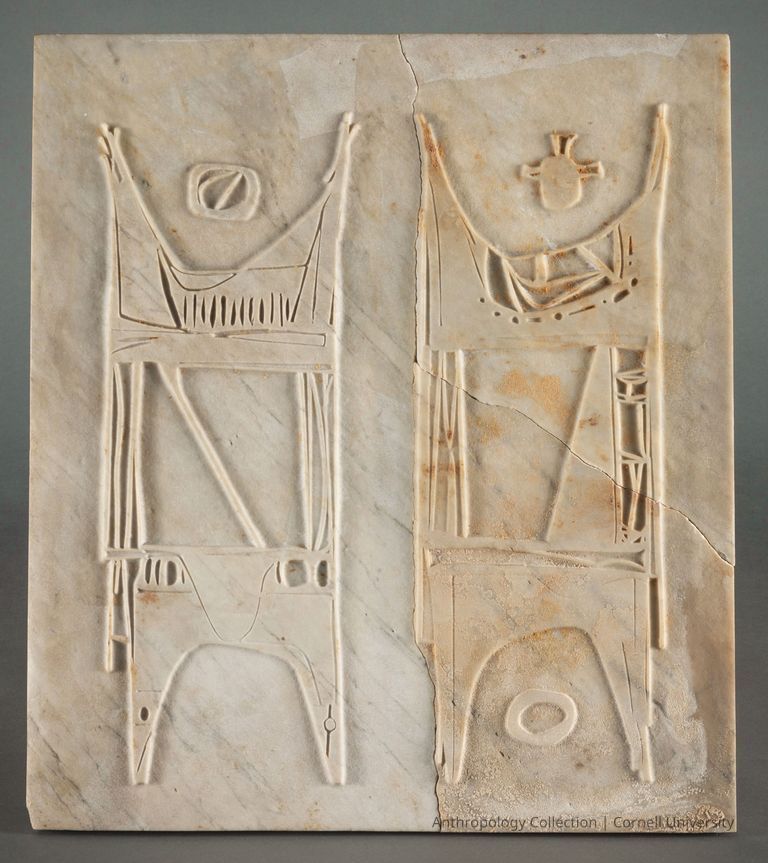 STELE WITH GODS TAL-HAX AND SHOR-NOO | circa 1959-1964 | Photo by Ann Cady, 2024 | ©2026 Norman Daly Art — A marble bas-relief, featuring symbolic figures in orant posture,  suggesting religious significance. The surface of the aging stone reveals cracks, suggesting its significant age While appearing quite like a work of mid-20th century art, it is an excellent example of the craftsmanship and artistic expression of an ancient era.