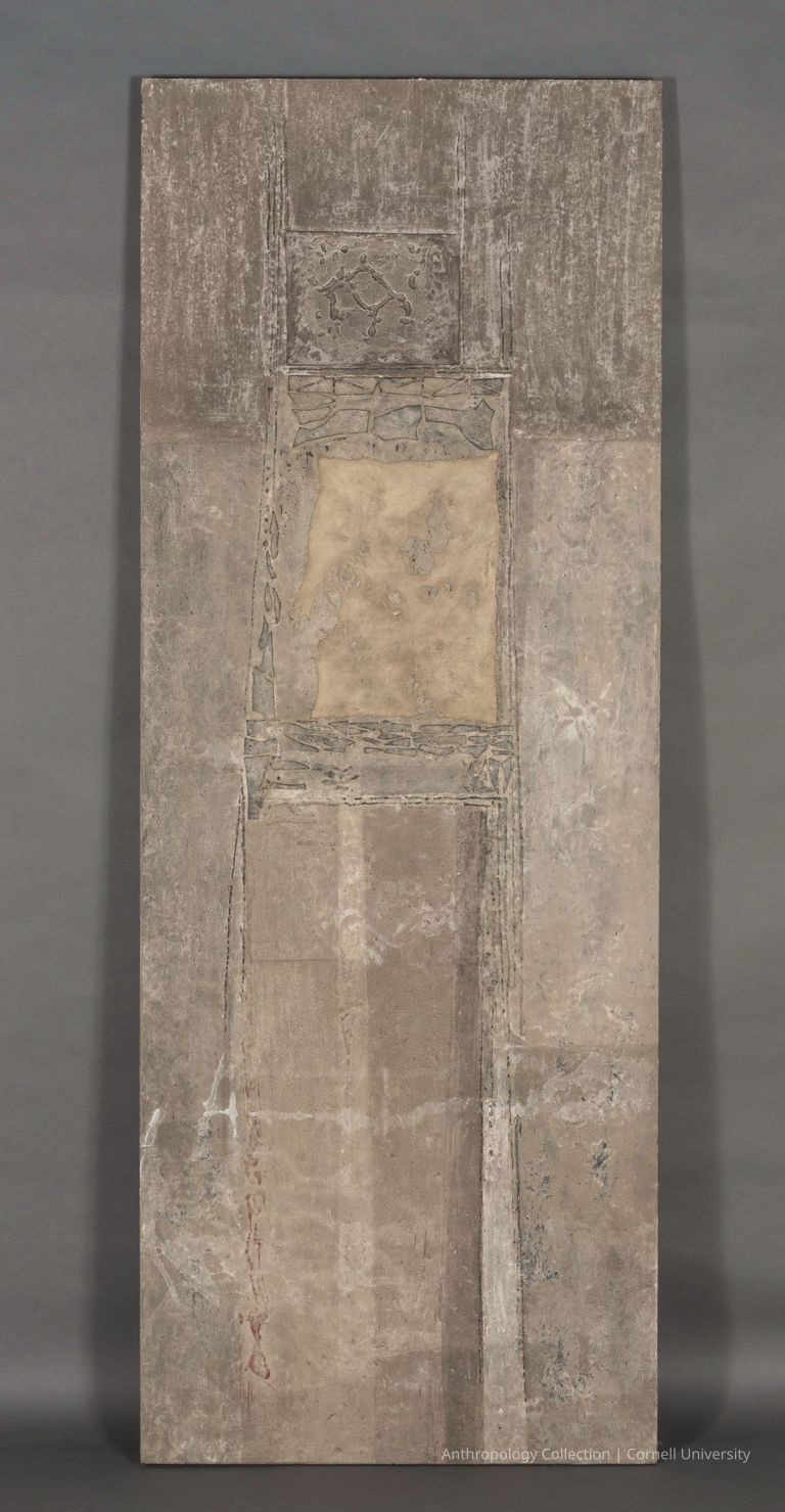 Temple Door | circa1966-71 | Photo by Ann Cady, 2024 | ©2026 Norman Daly Art — This object is characterized by a series of carved geometric patterns and muted earth tones, highlighted in lighter shades, surrounded by a textured surface that integrates vertical and horizontal elements, creating a sense of depth and balance.