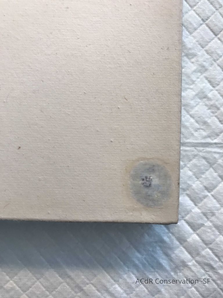 In progress detail shot bottom left corner. After sanding back white oil paint to realign texture, it is decided that due to a bulge from the nail head and projected difficulties in colour/texture matching, this line of work will not be continued and the discoloured paper will be removed and the problematic nails below also removed. 