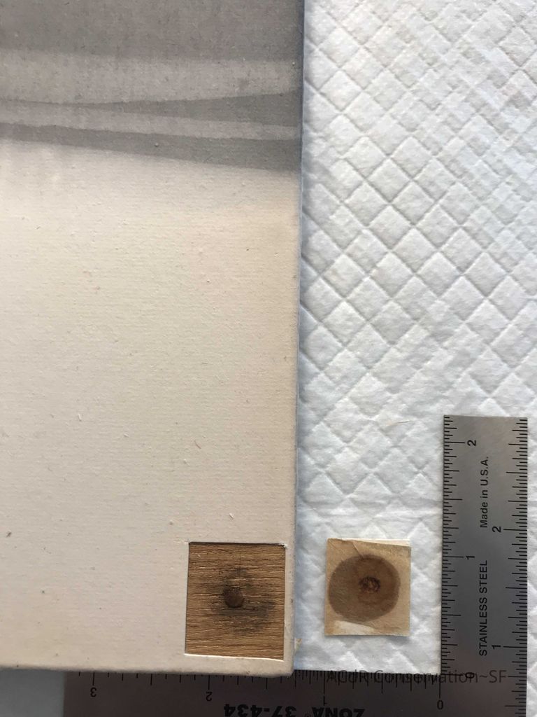 Removed square of discoloured paper revealing nail; this also showed that the paper is only glued to the board on the sides, not the face of the work, therefore it will be able to be removed from the wooden stretcher and problematic nails. 