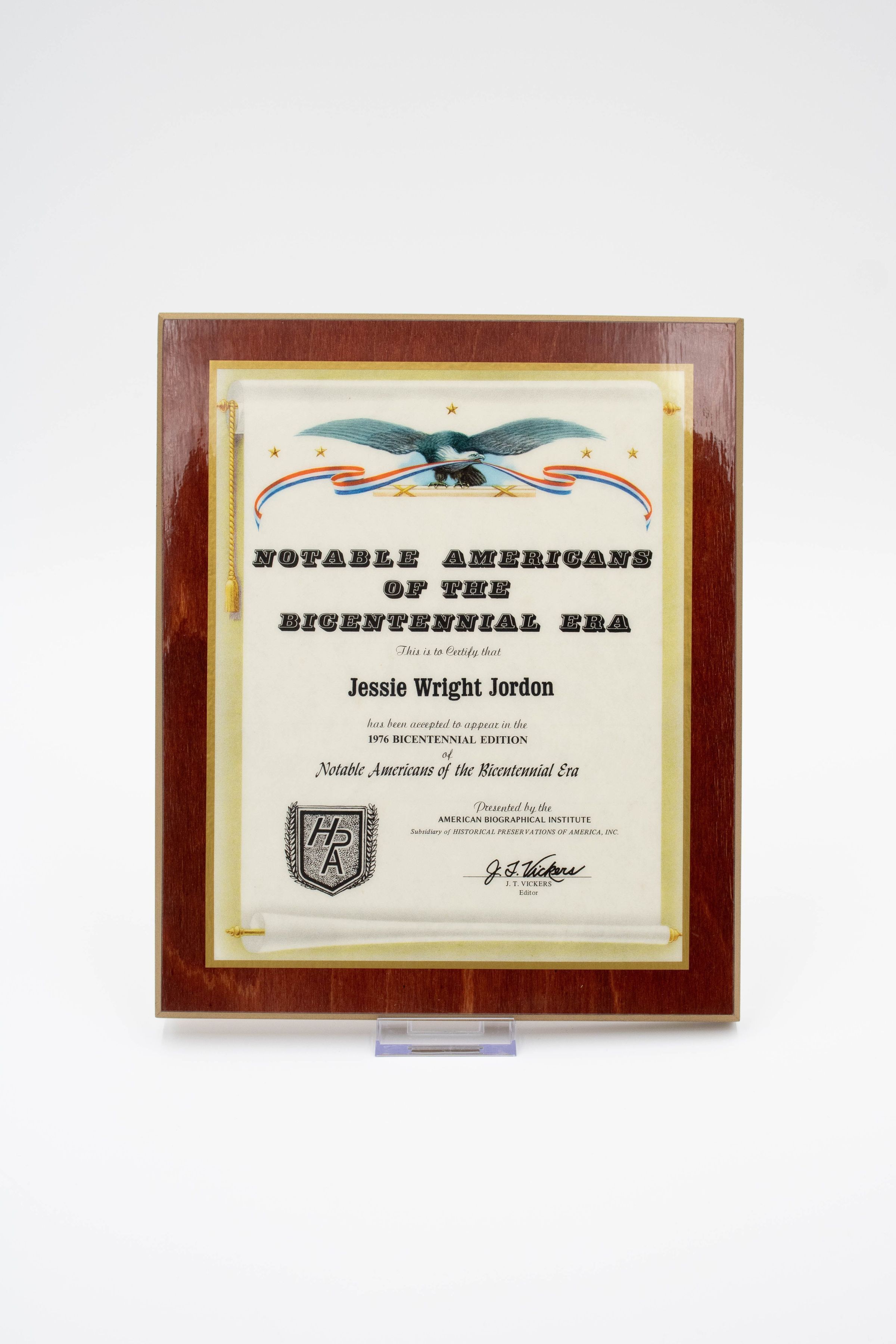 Notable Americans of the Bicentennial Era Certificate: Image of a plaque that recognizes Leland Thomas Jordan as a notable American in the Bicentennial Era. The surface of the certificate has a sheen and it has a brown wood border. An eagle with its wings stretched out and with a red, white, and blue banner in its beak accompanies the top of the certificate.