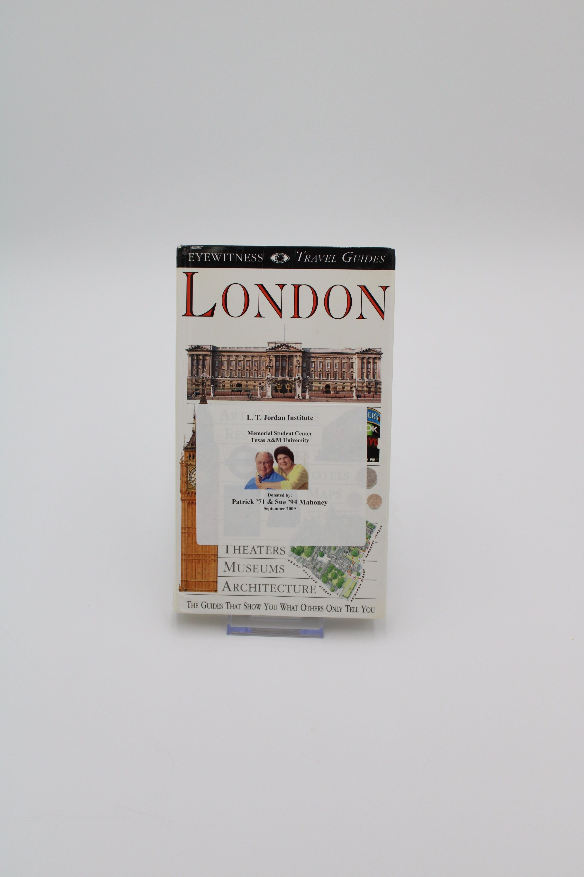 Front Cover: The front cover of "London" features colored photographs of several notable hallmarks of London, such as Big Ben, Buckingham Palace, and double-decker busses. Much of the front cover is occupied by a semi-transparent white sticker referencing that the book was donated to the L.T. Jordan collection by two Texas A&M alumni, Patrick '71 & Sue '94 Mahoney.