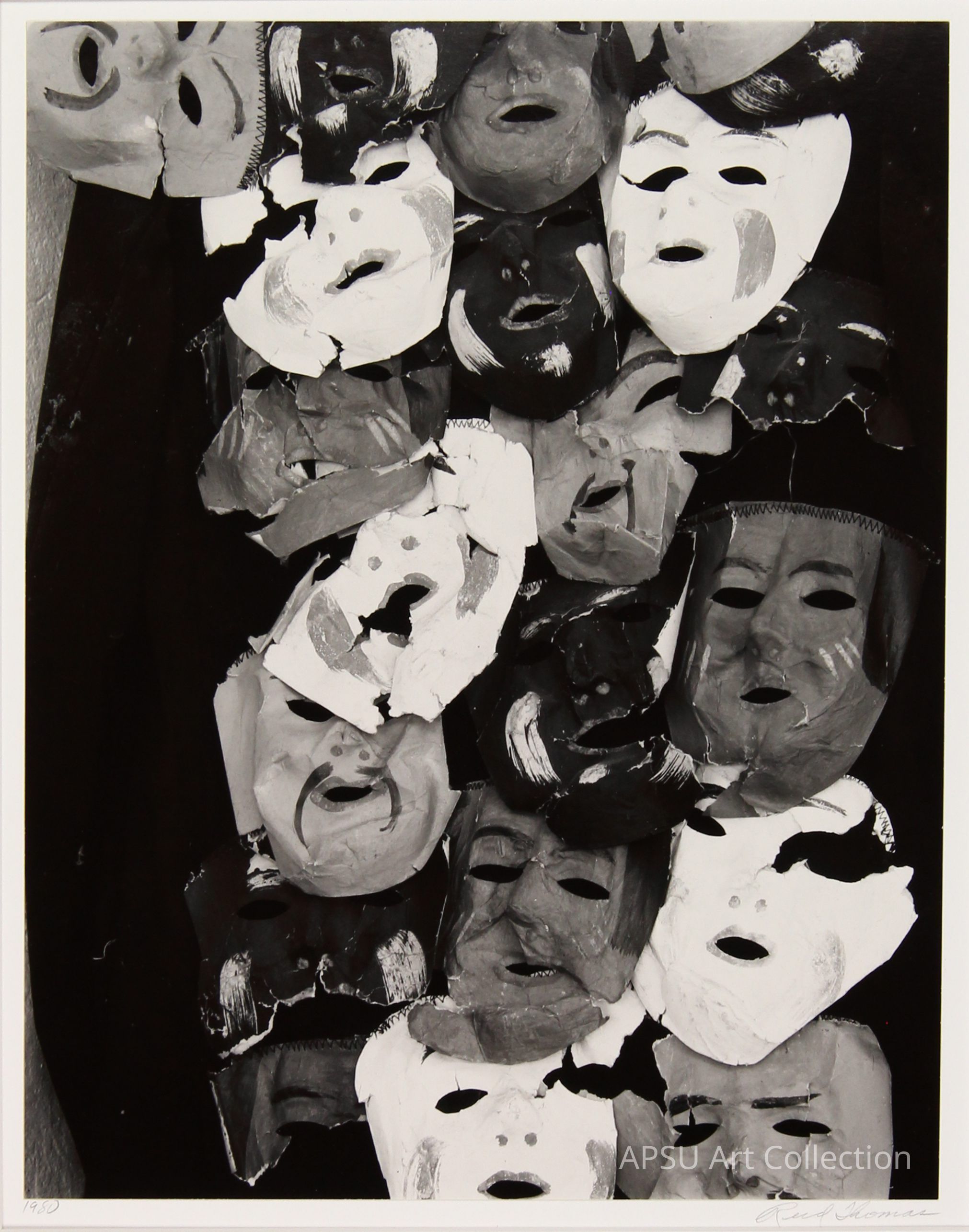 The image presents a textured and densely clustered array of numerous overlapping masks, each featuring different expressions and styles, captured in a monochrome black and white photograph which emphasizes their dramatic and eerie qualities. The masks range from smiling to somber, creating a haunting mosaic of human-like faces, each harboring their unique persona, yet unified in their stark presentation against a dark backdrop. This artistic assembly provokes a thoughtful reflection on identity and the masks we wear.