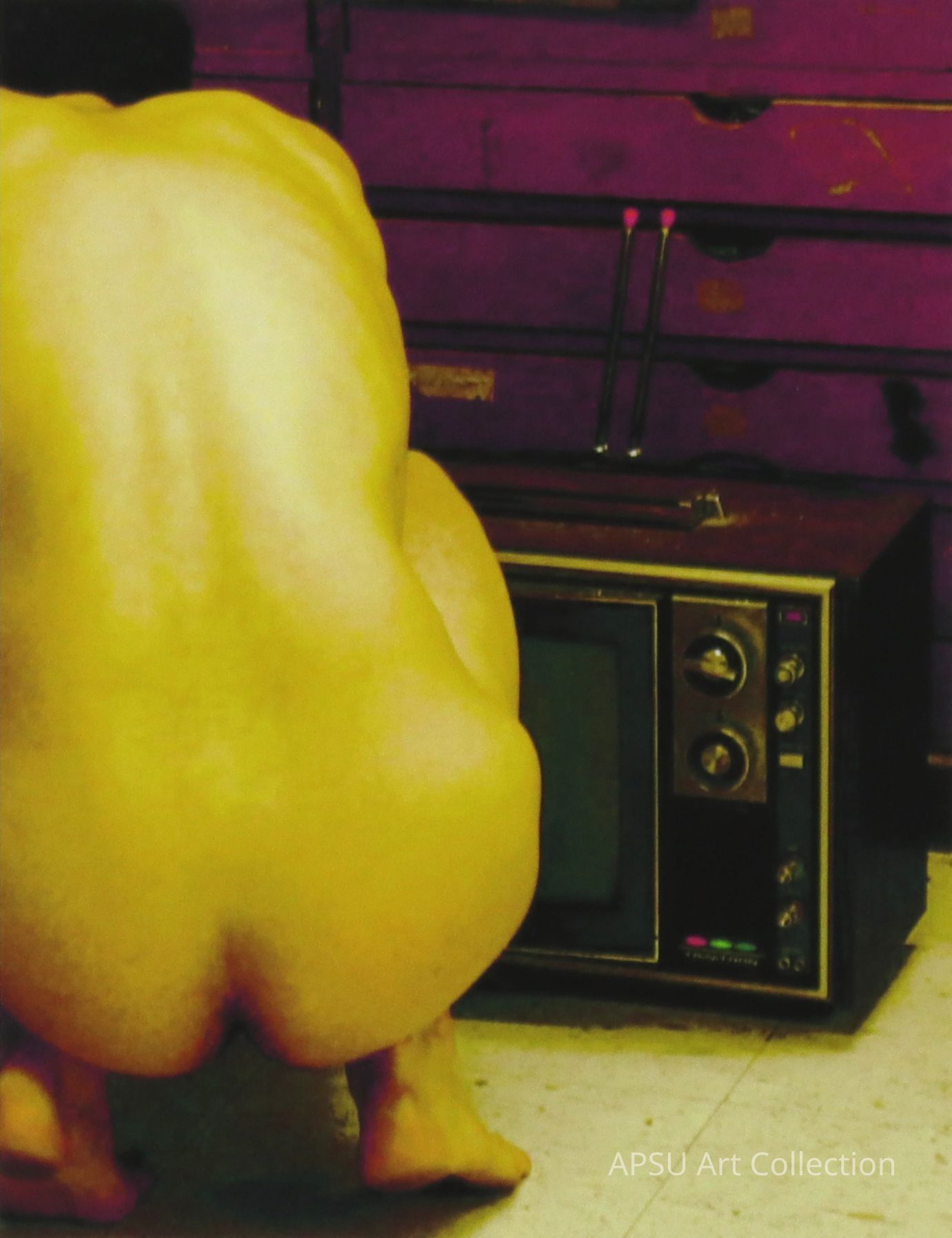 Image of a nude figure from behind- the figure is squatting low above the ground, and is cropped of slightly on the left. To the right of the figure is an old tv, with a set of drawers behind that. The color is not very realistic- the figure is a stinging yellow, the set of drawers a very striking magenta.