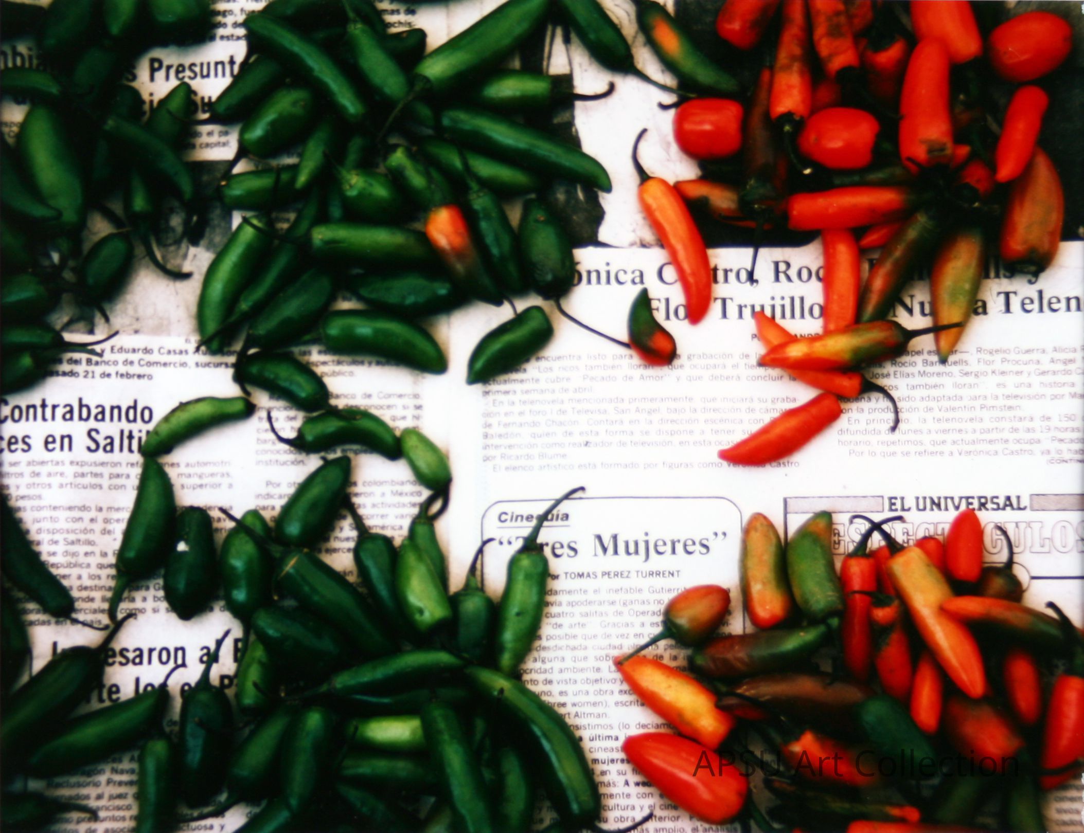 The image displays an assortment of fresh green and red chili peppers scattered over sections of a newspaper, with visible Spanish text that includes phrases like "Contrabando de armas en Saltillo" and headlines referring to cultural topics and soap opera news. The juxtaposition of vibrant organic produce against the background of printed media suggests a blend of daily life and culture in a Hispanic setting.