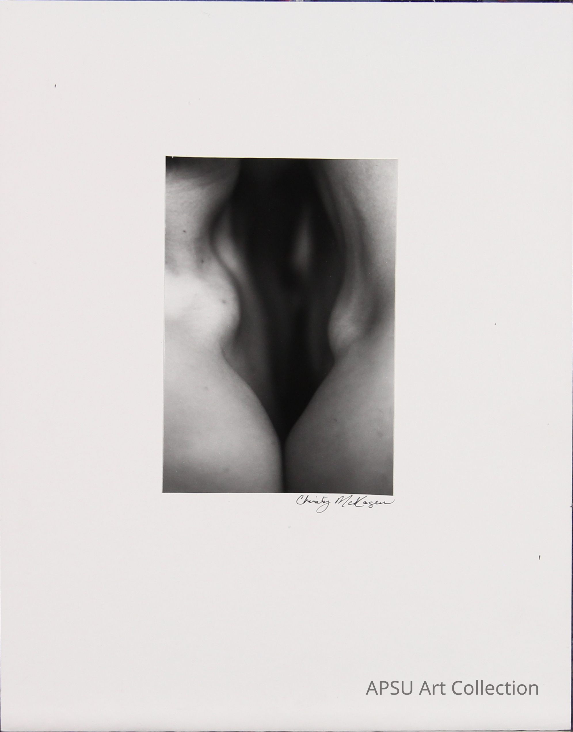 This black and white photograph by Charis Wilson Weston features an abstract close-up of the human form, where the interplay of light and shadow creates a striking and sensuous depiction of skin and contours; the central composition draws the eye towards the subtle curves, leaving much to the imagination while maintaining an elegant and artistic expression.
