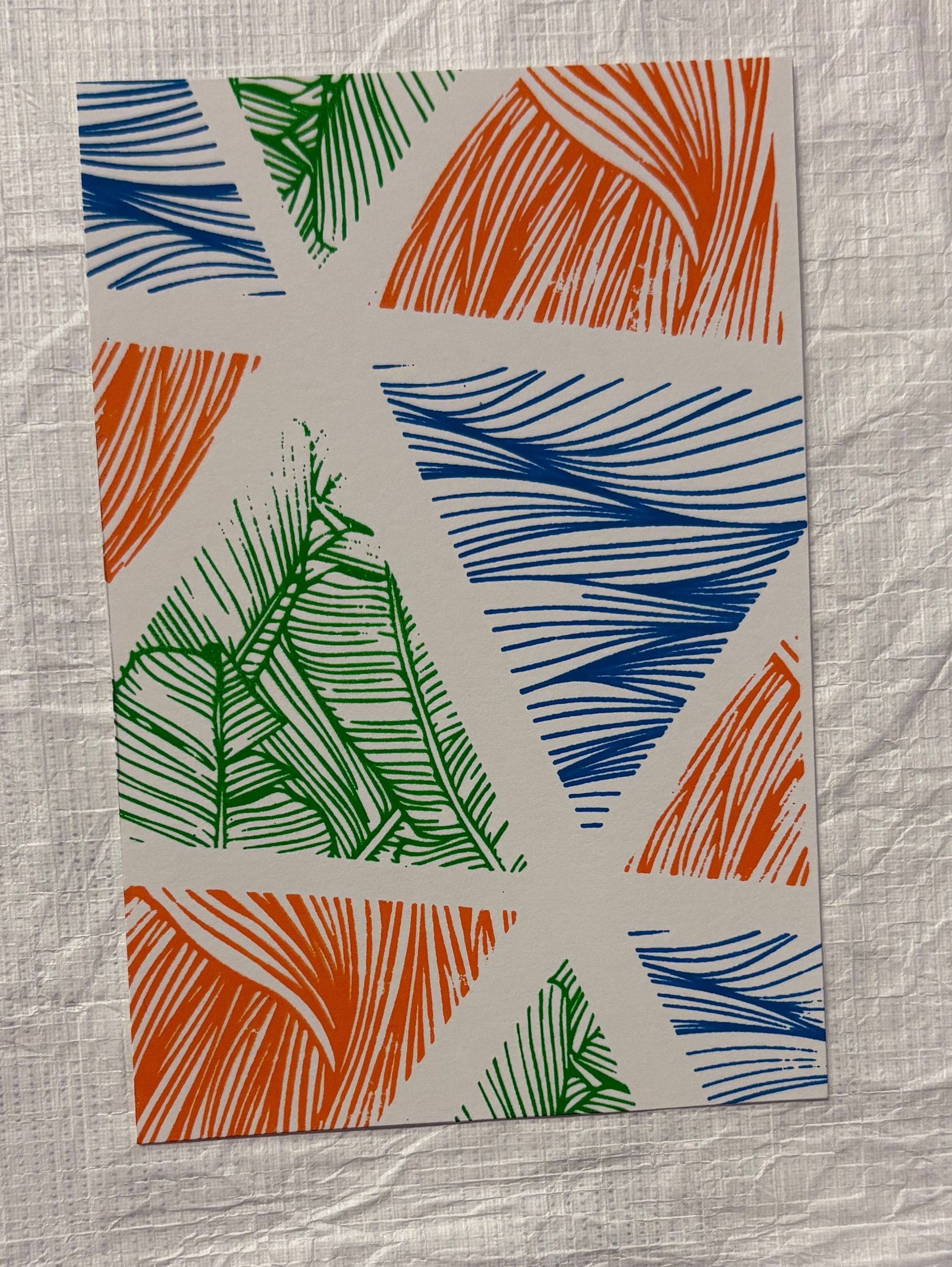 Front: A small, vertically oriented print that is done on white ground and has spaces of blue, orange and green. The print is constructed of geometric/triangular shaped windows that are decorated and filled with line and foliage like patterns that change from space to space. These areas are divided by negative areas of space that are these thick, white bands.