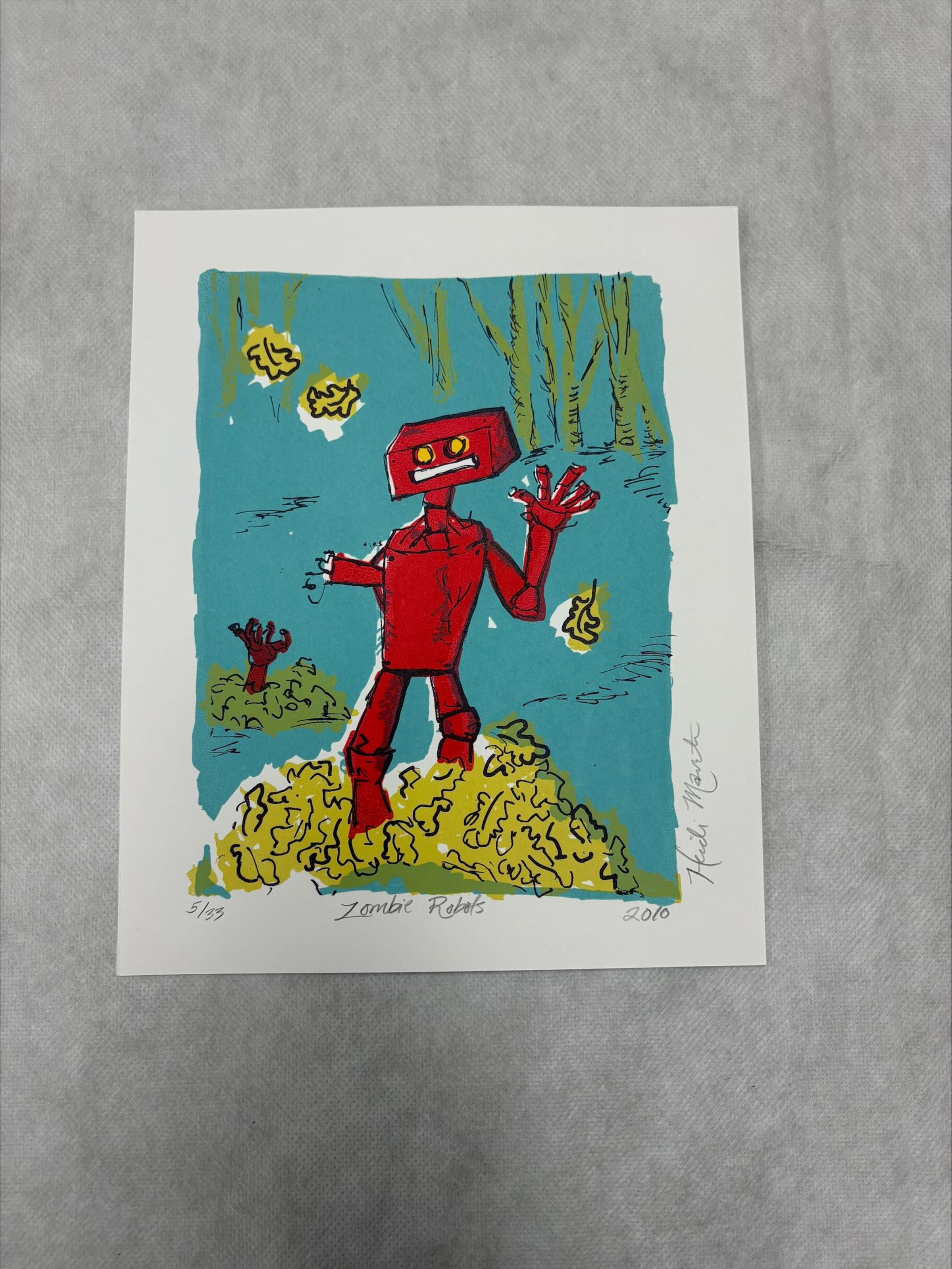 Front: A vertically oriented, medium sized print that uses blue, green, red primarily with white and black being used for outlining or for highlights. The print shows an artistic rendering of robots as they rise from the ground like zombies in a swamp like landscape
