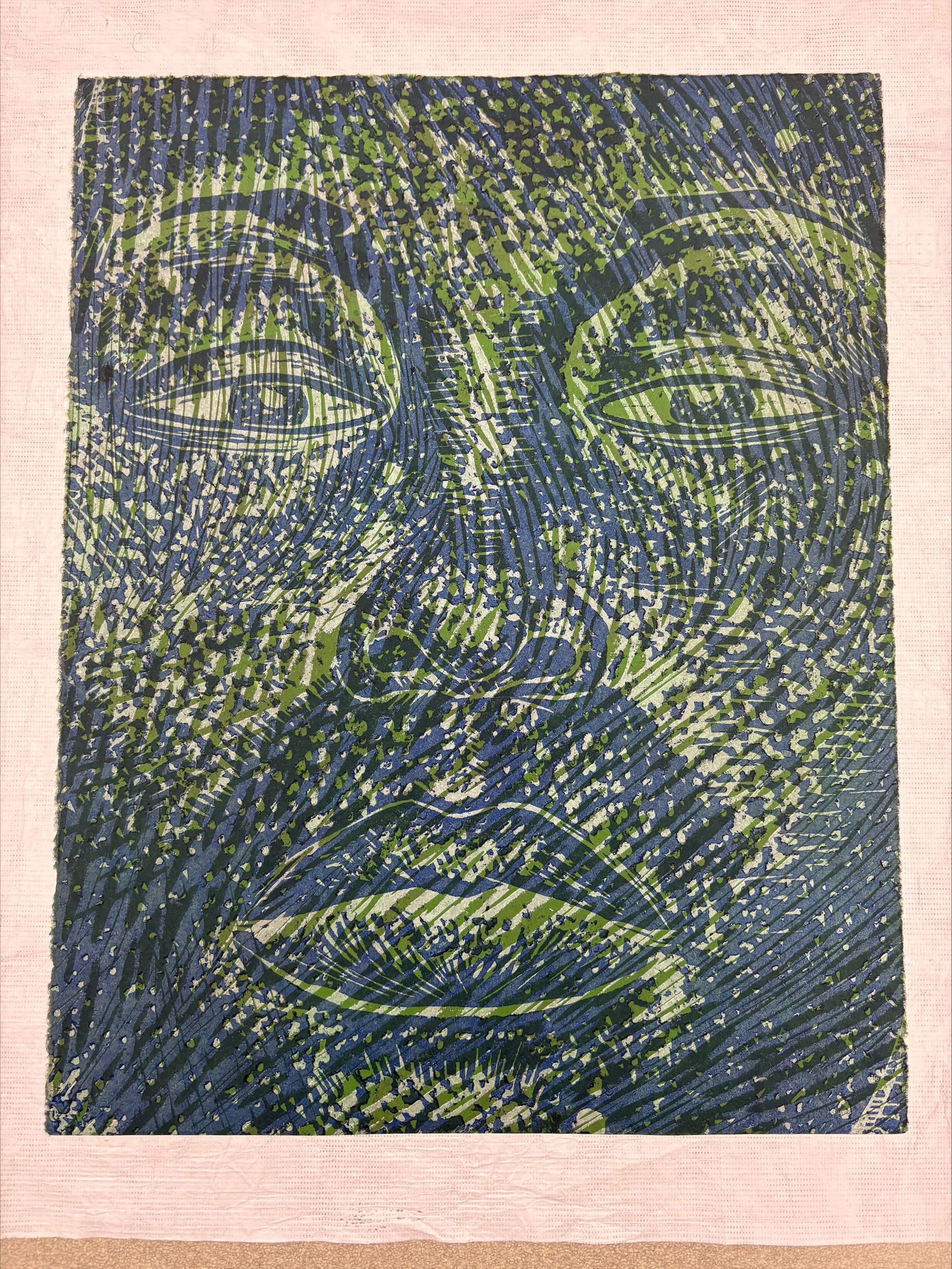 Front: A vertically oriented, medium sized print that uses primarily blues and greens to compose the subject of the print. The print is that of an enlarged face that has been cropped at the edges to only show the eyes, nose, and lips of the figure.