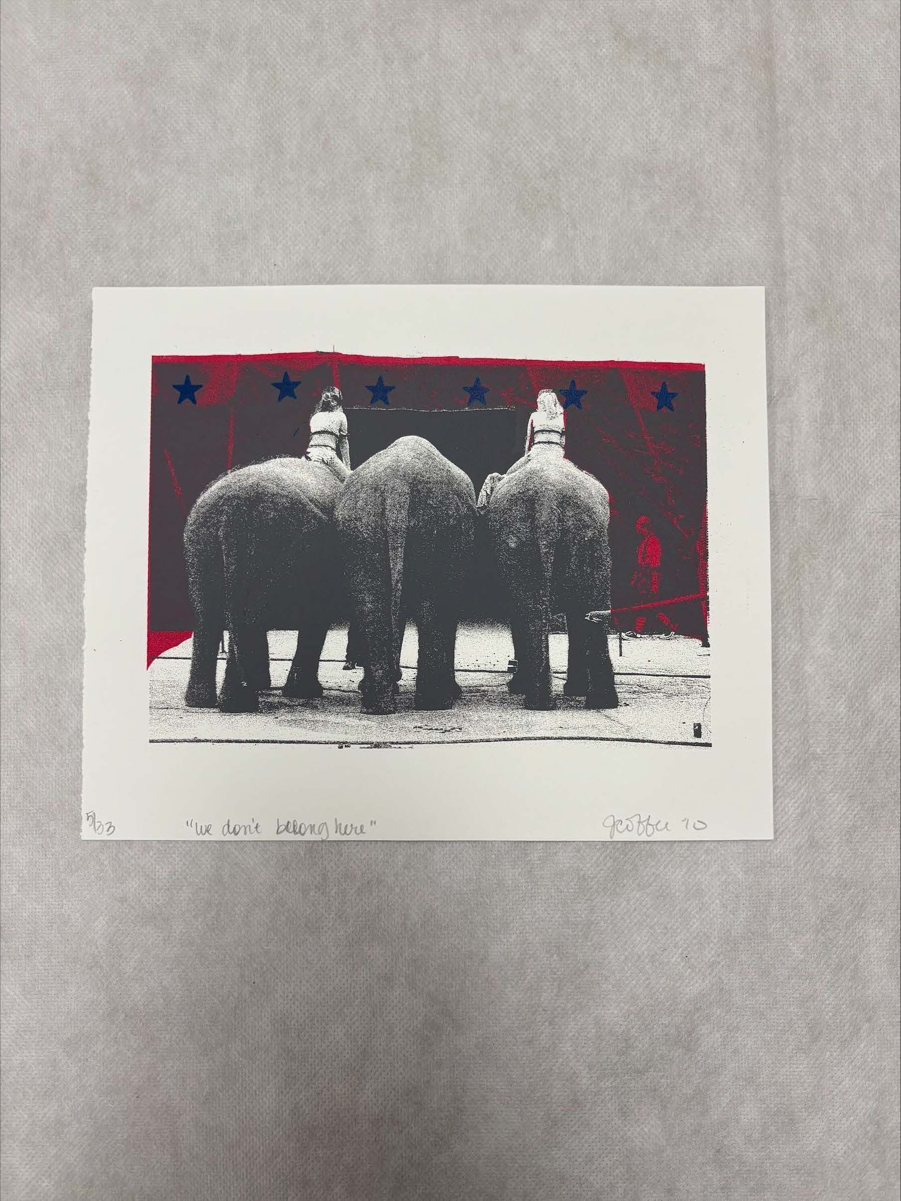 Front: A horizontally oriented, medium sized print that uses pigments such as red, blue, white, black and shades of grey. The print depicts the back view of three elephants lined up in the central region of the print with two women sitting on an elephant on each end. Around the central scene there is a red curtain with blue stars placed along the top.