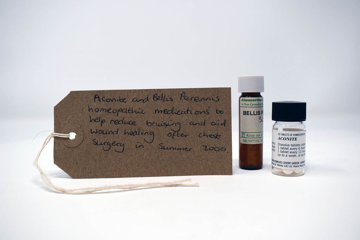 The image shows two homeopathic medication bottles and a handwritten label detailing their intended use.