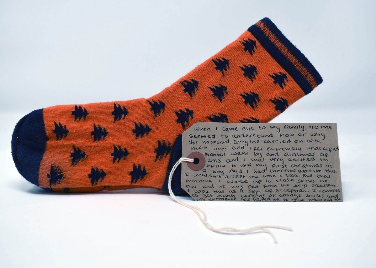 Orange socks with navy blue tips, heels, top hems, and tree pattern.
