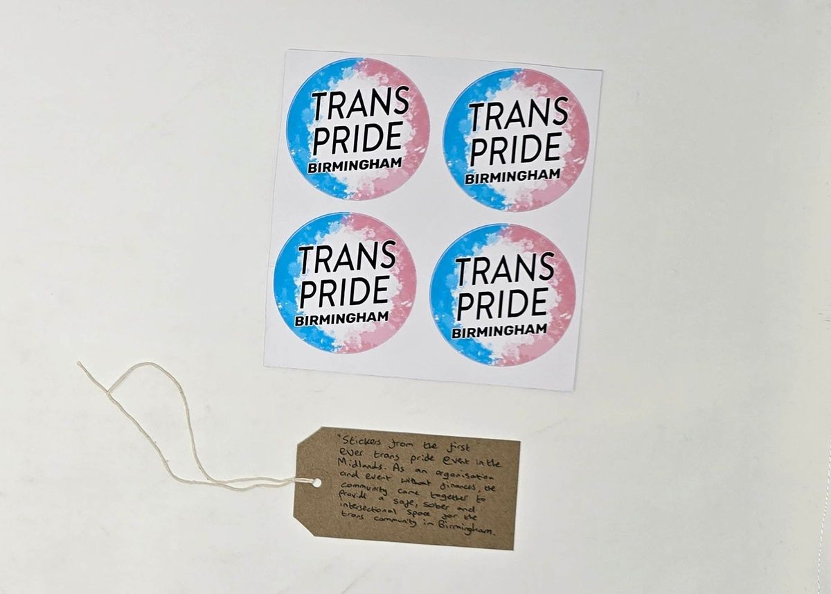Sheet of 4 stickers in trans pride colours reading "TRANS PRIDE BIRMINGHAM". Underneath is a tag reading "Stickers from the first ever trans pride event in the Midlands. As an organisation and event without finances, the community came together to provide a safe, sober and intersectional space for the trans community in Birmingham."