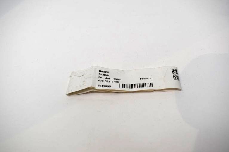 A white hospital bracelet in the name of Sarah Baker.