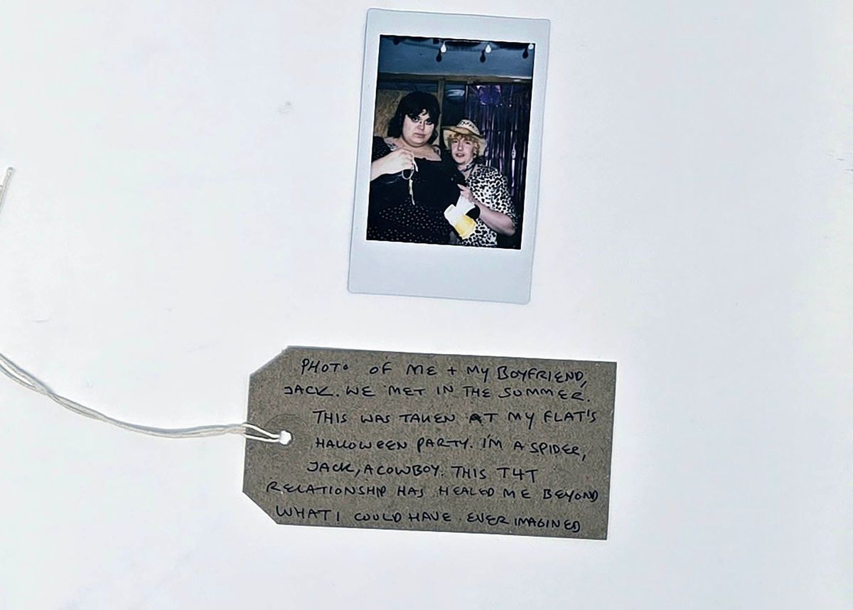 A photo displays two people in costumes at a Halloween party, accompanied by a heartfelt handwritten note.