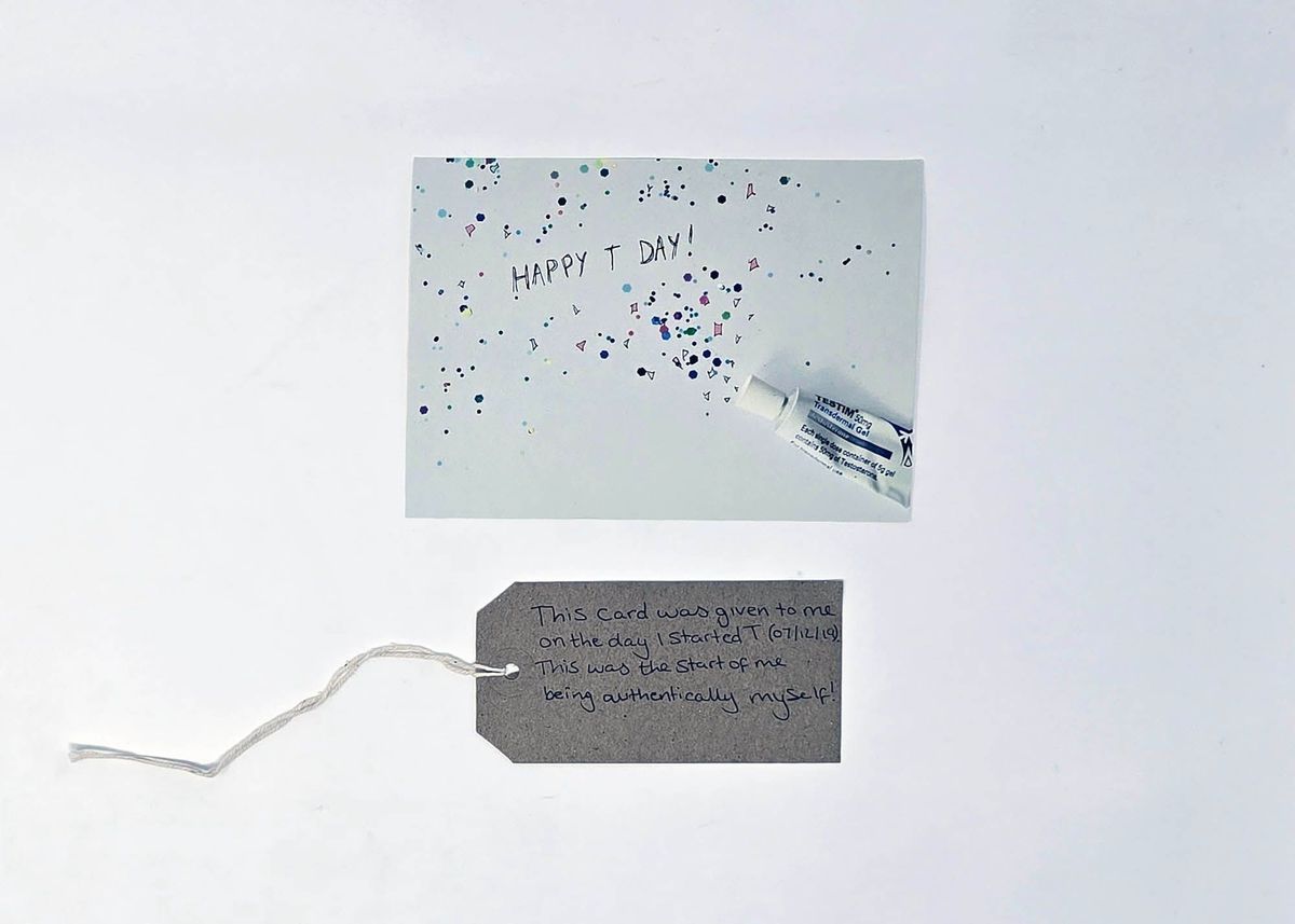 A card depicting a tube of Testim with confetti coming from it and the text "HAPPY T DAY!". With a brown, handwritten luggage tag.