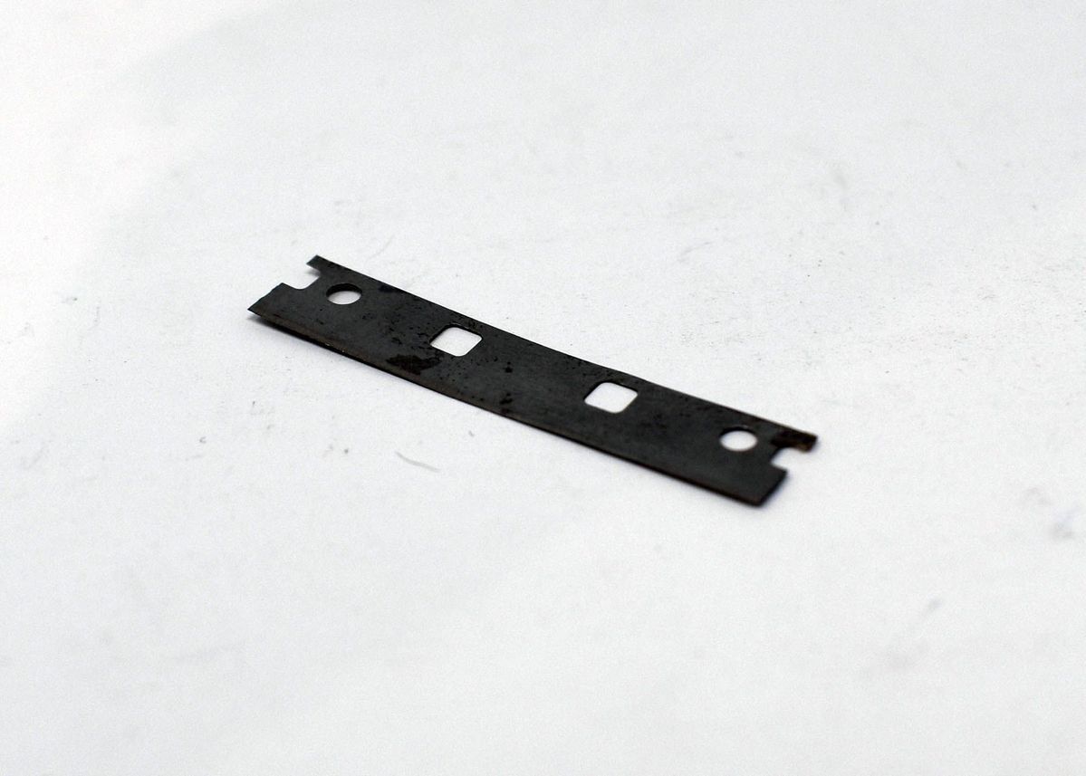 A dark grey safety razor blade