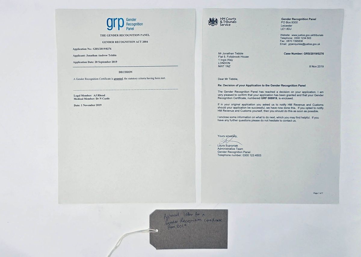 Two A4 pages of an approval letter from the Gender Recognition Panel, confirming their decision to grant a Gender Recognition Certificate. With a brown, handwritten luggage tag.