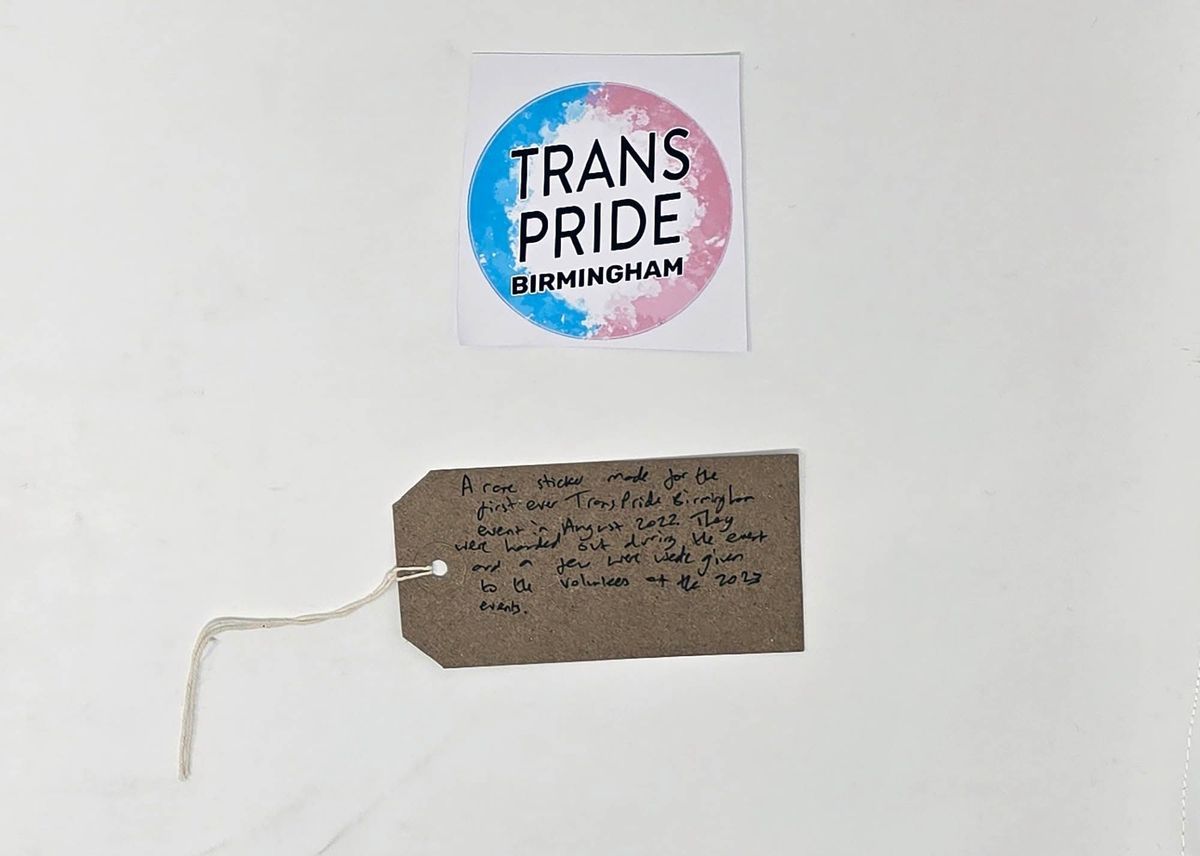 Trans Pride Birmingham sticker, alongside tag.
