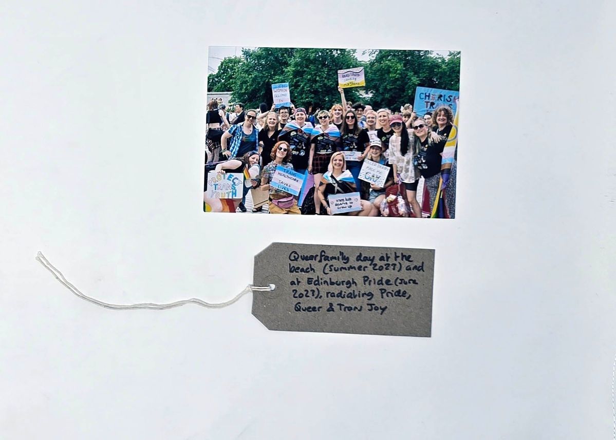 A diverse group joyfully celebrates at a pride event, holding colorful signs promoting inclusivity and support.