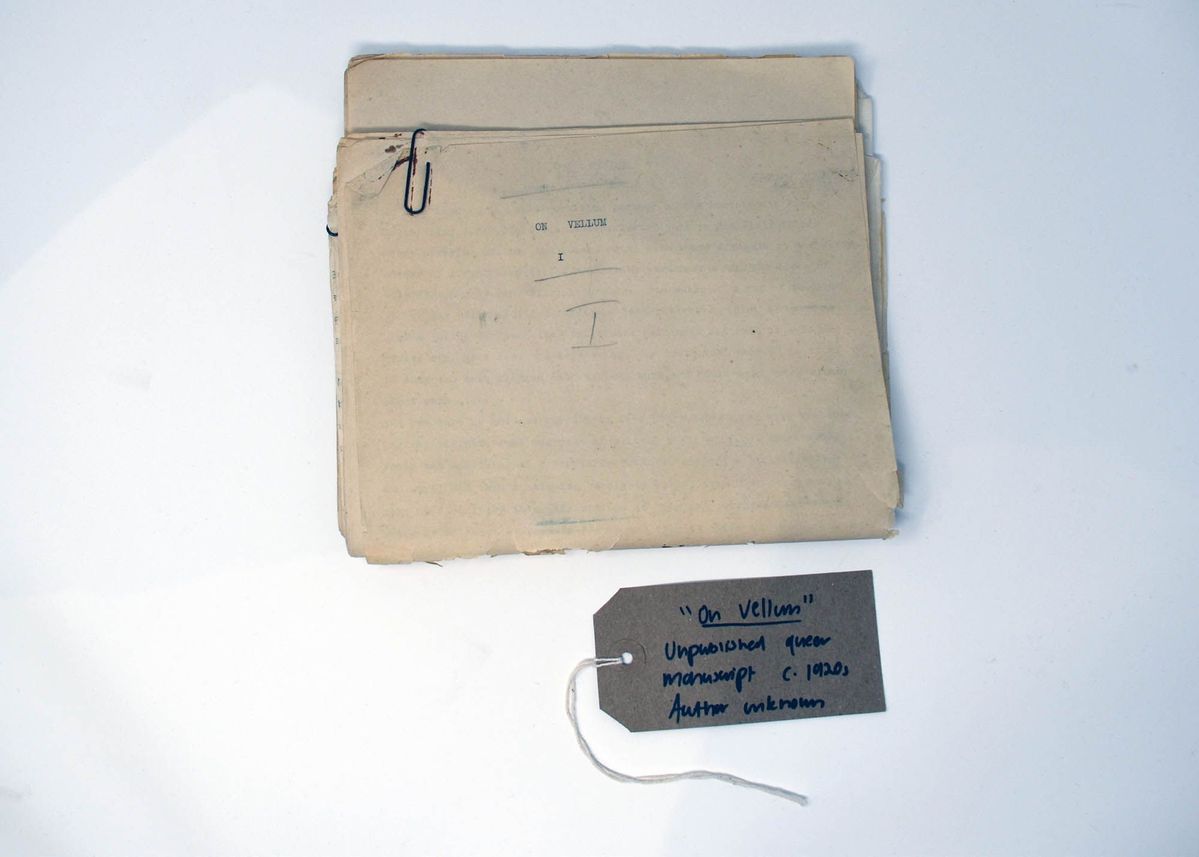 An old manuscript written on vellum, entitled "On Vellum". With a brown, handwritten luggage tag.