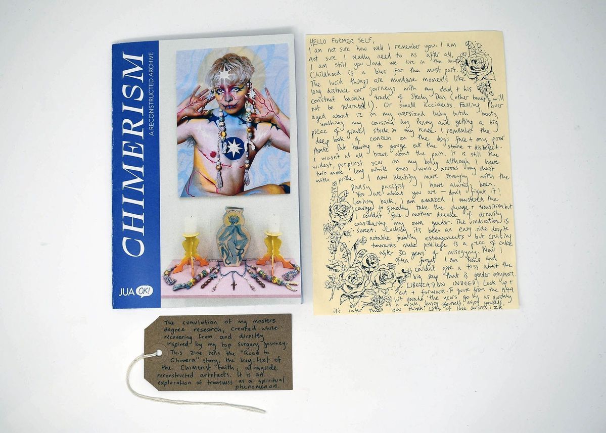 The image shows a book titled "CHIMERISM" alongside a handwritten letter and a small tag.