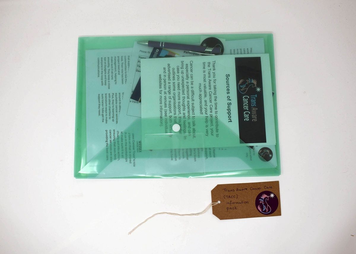 A green folder labeled "Trans Aware Cancer Care" contains informational materials and a pen.