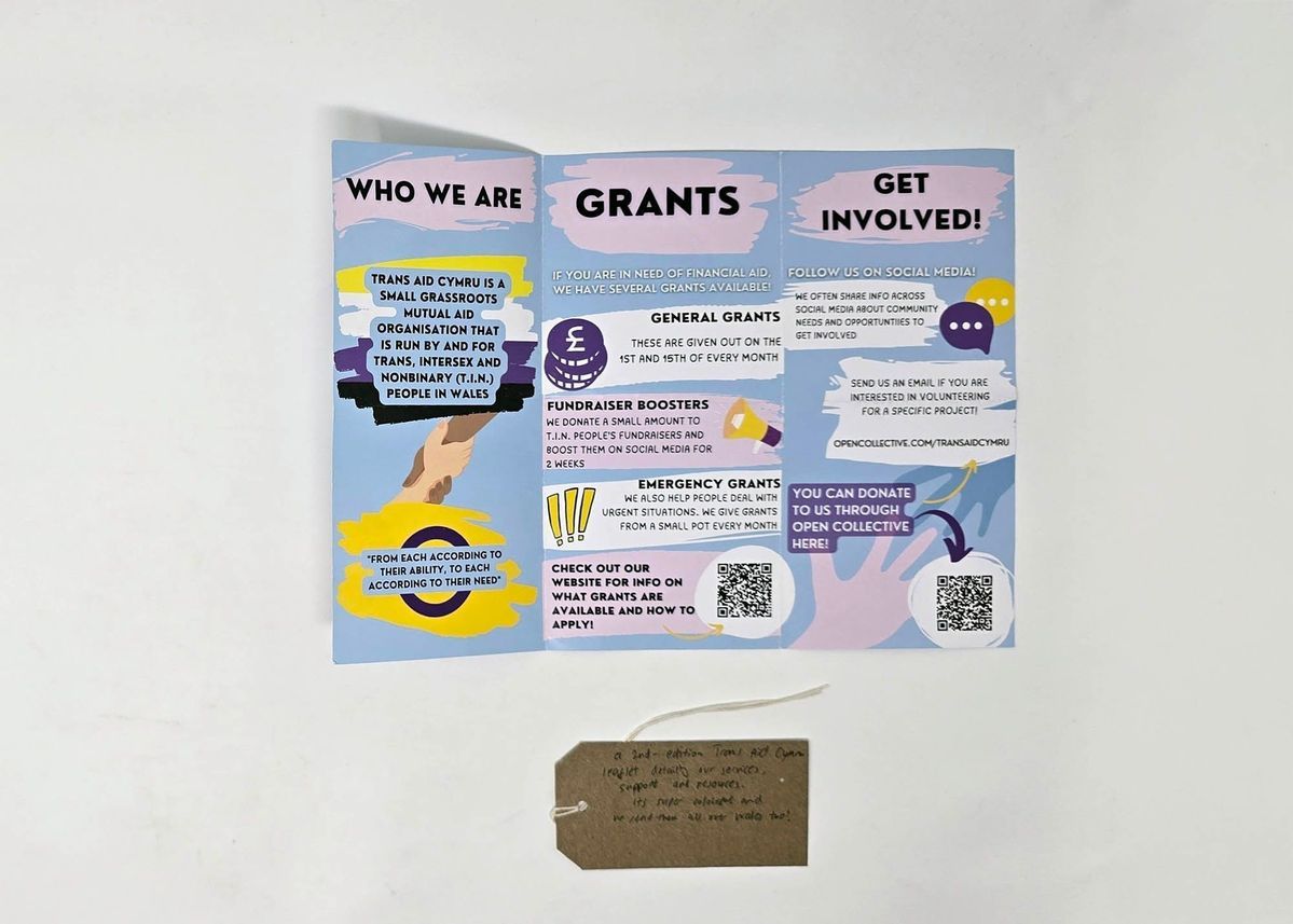 Trans Aid Cymru flyer deatailing the services on offer. With a brown handwritten luggage tag.