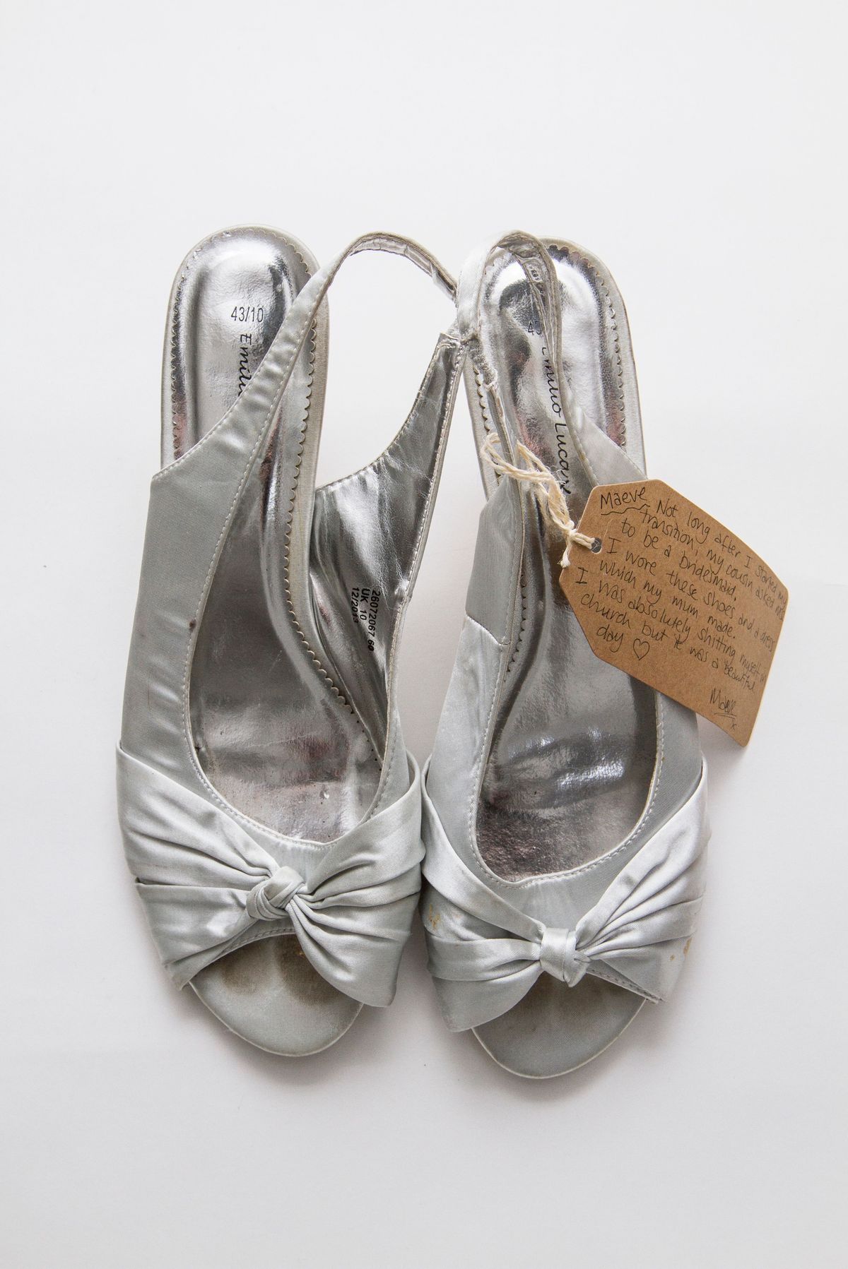 Silver open-toed shoes with soles reading "43/10 Emilio Luca X".