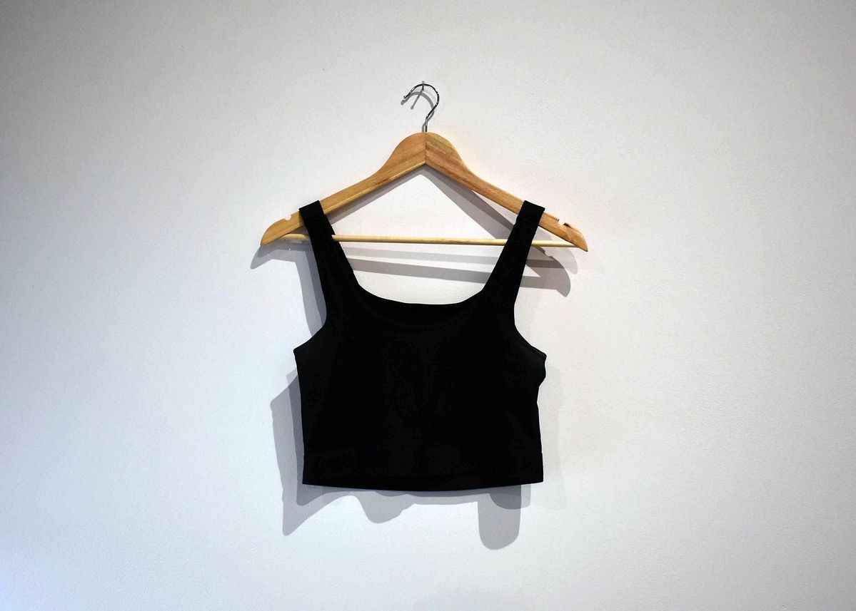 A black binder on a wooden hanger.