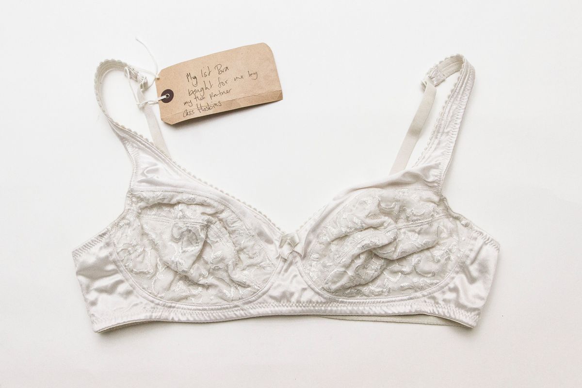 A white bra with lace and embroidered details.