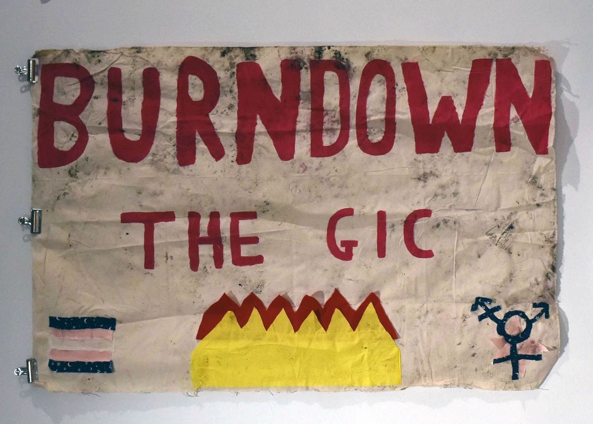 "Burn Down the GIC" cloth banner.