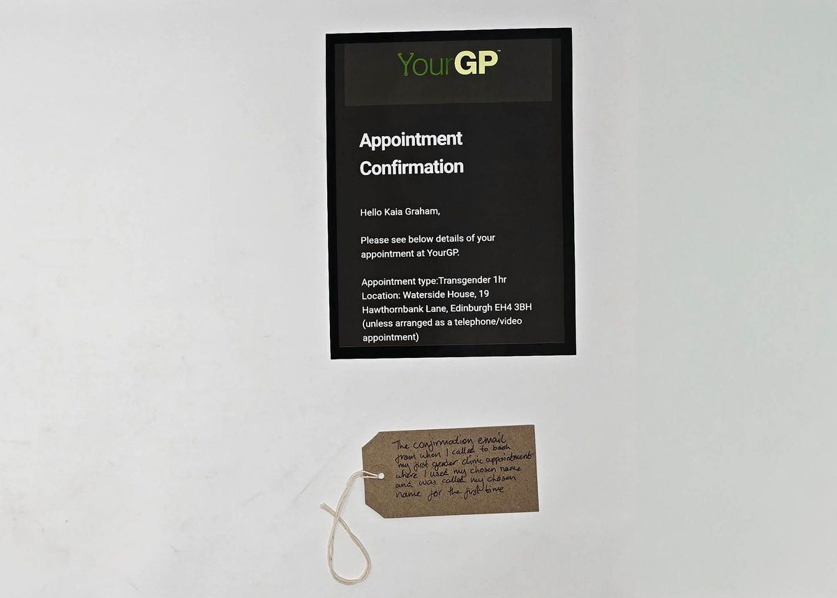 Photograph of an appointment confirmation message from YourGP. With a brown handwritten luggage tag.
