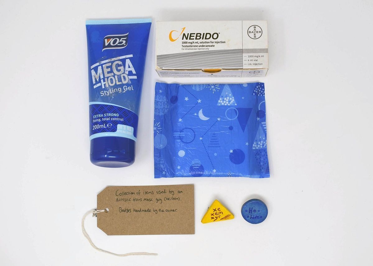 The image shows a styling gel, medication box, sanitary pad, badges, and a handwritten tag.