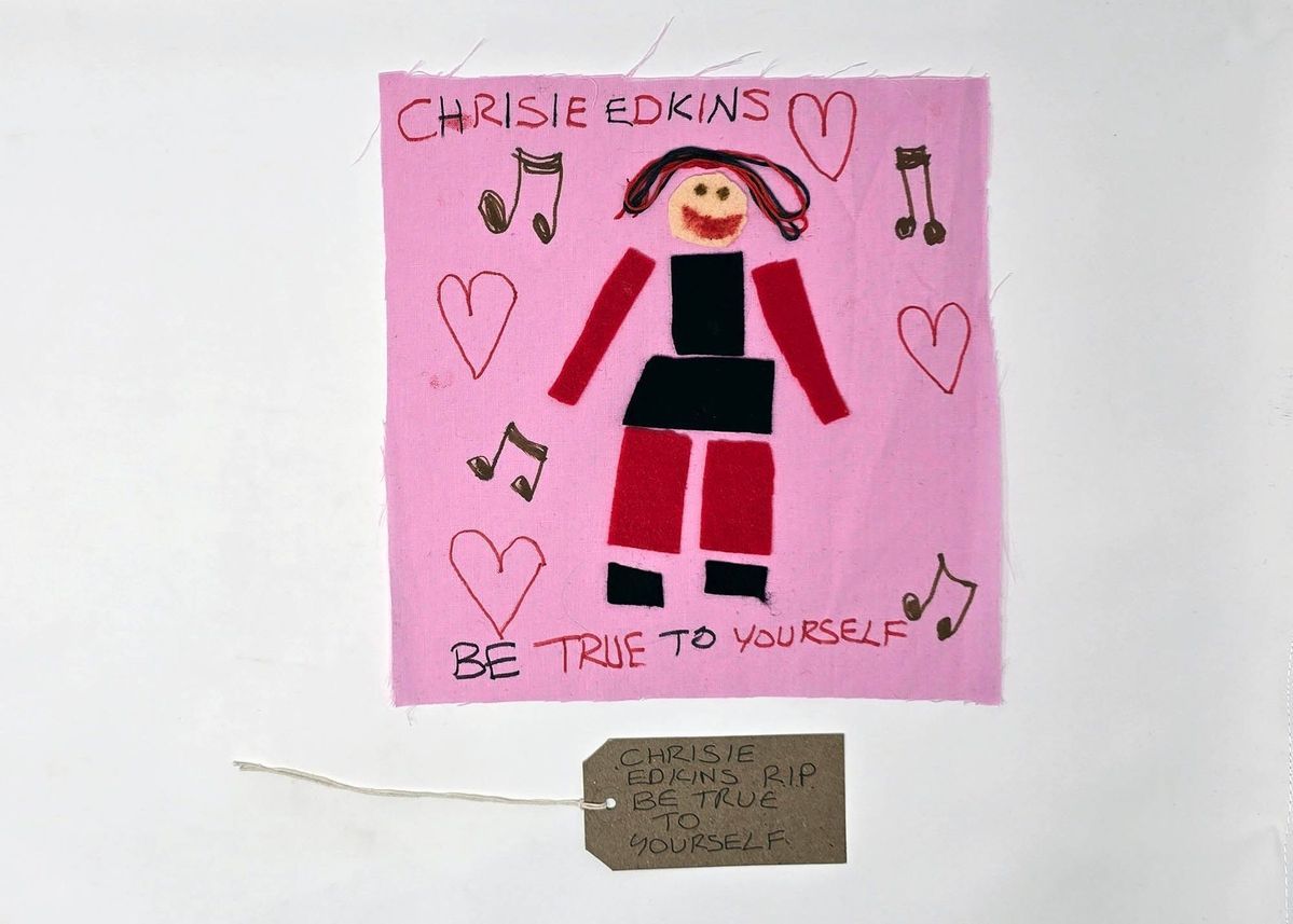 The image shows a colorful drawing with musical notes, hearts, and text saying, "Be true to yourself"