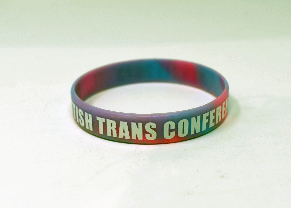 A rubber wristband which is colourful and says 'British Trans Conference'.