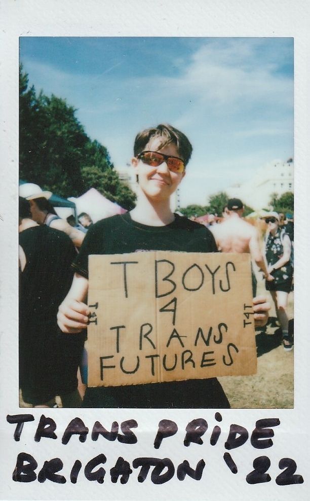 A person is holding a sign that reads "T Boys 4 Trans Futures" at Trans Pride Brighton.