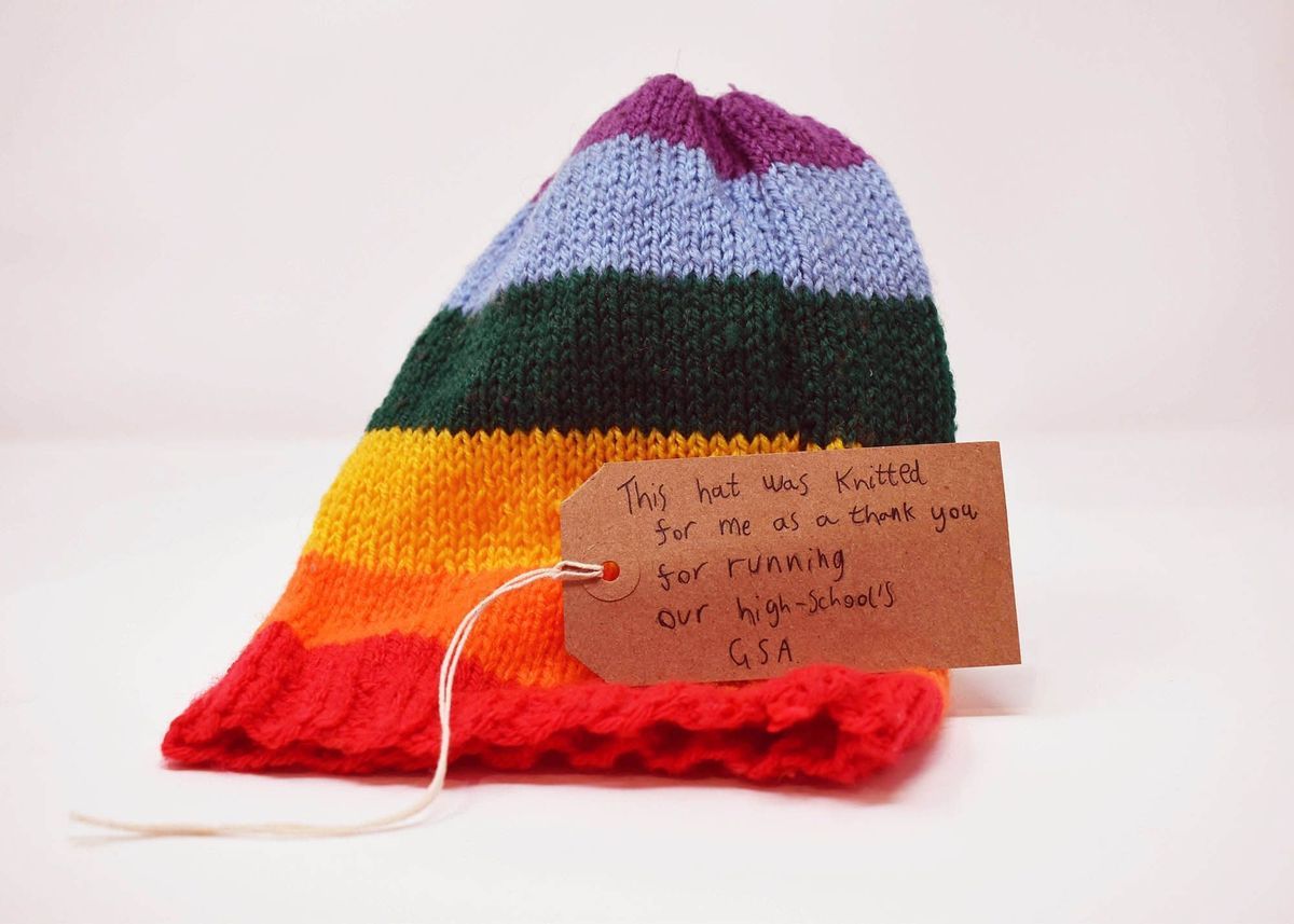 A knitted rainbow hat.