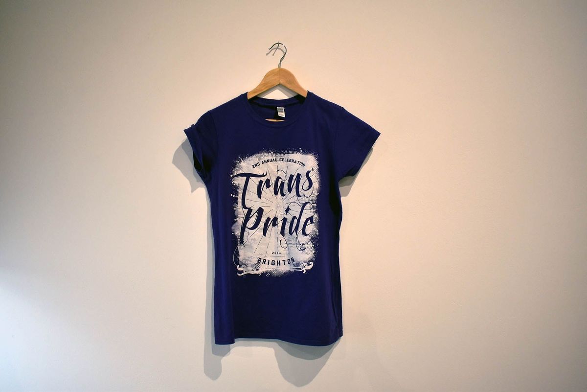 Purple T-shirt with white block and the words "2ND ANNUAL CELEBRATION TRANS PRIDE 2014 BRIGHTON" cut out.