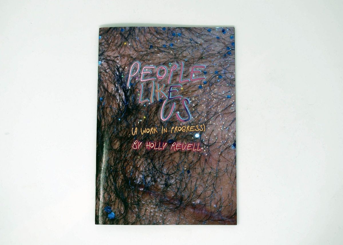 The book cover features colourful, handwritten text which says 'People Like Us: A Work In Progress By Holly Revell' on a background photograph of a hairy chest which is sparkling with gems and glitter.