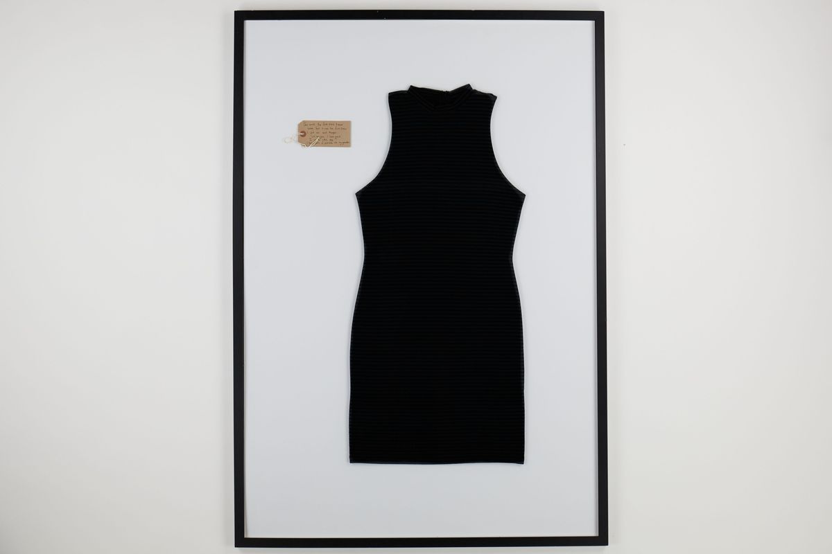 Black sleeveless dress with grey stripes in a frame with a brown tag within the frame in the top left.