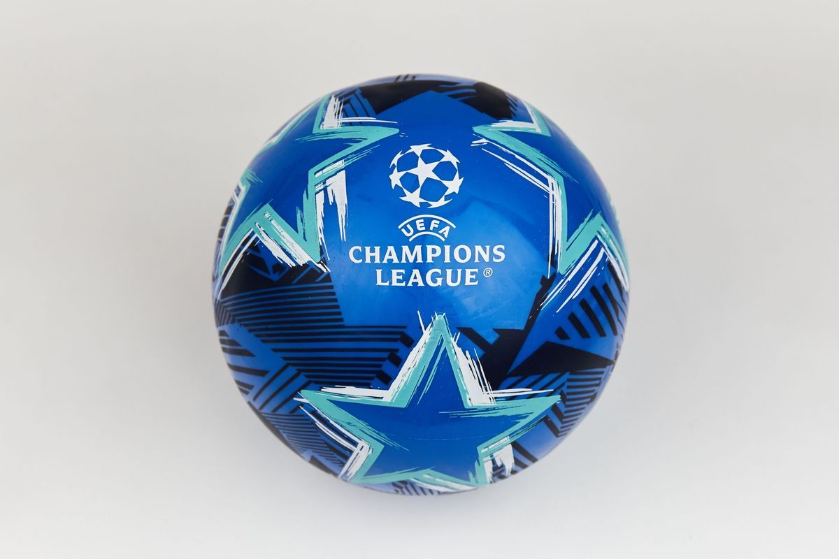 A blue UEFA Champions League football. It is decorated with agree and white five painted stars and black lines.