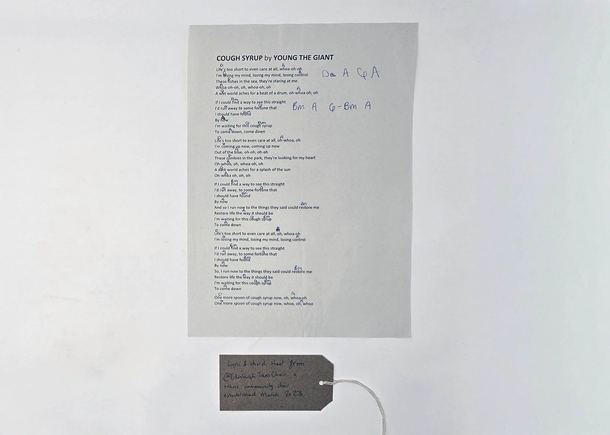 Lyrics to the song "Cough Syrup" by "Young the Giant" annotated with musical chords. With a brown, handwritten luggage tag.