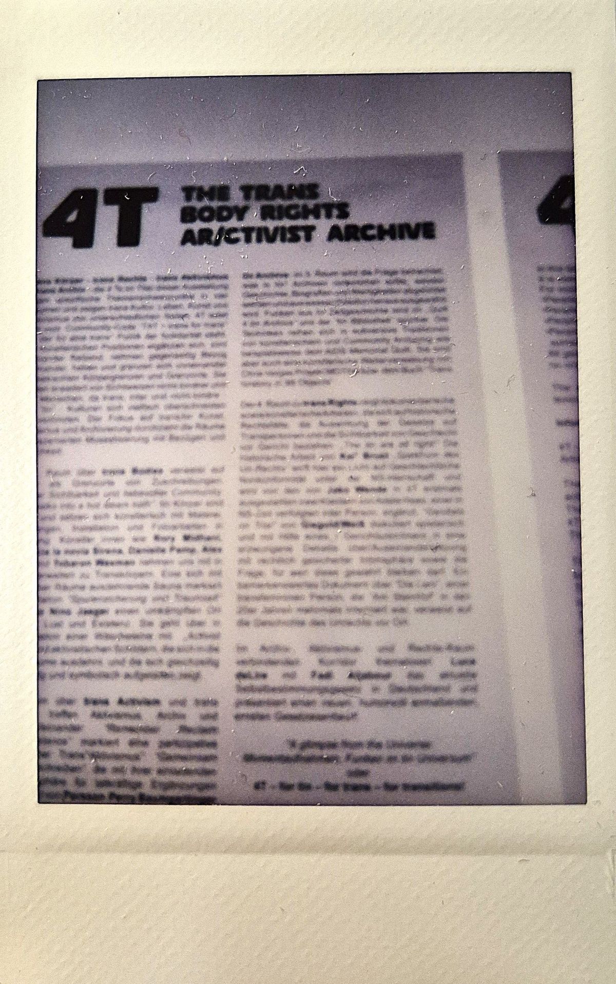 The photograph displays a document titled "The Trans Body Rights Activist Archive" with partially obscured text.