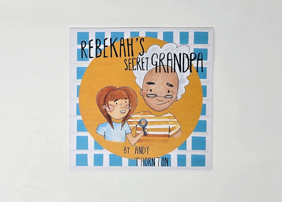 Photograph of the book 'Rebekah's Secret Grandpa' by Andy Thornton which shows an illustration of a young person with long brown hair and an older person with grey hair and glasses. The younger person is holding a magnifying glass.
